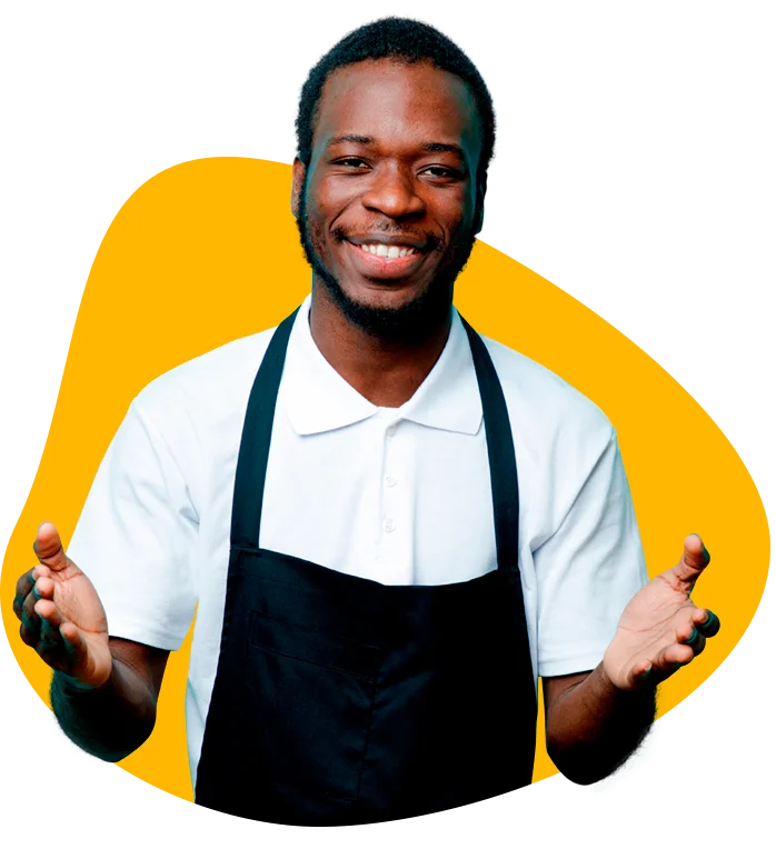 Smiling young man with open arms in black apron